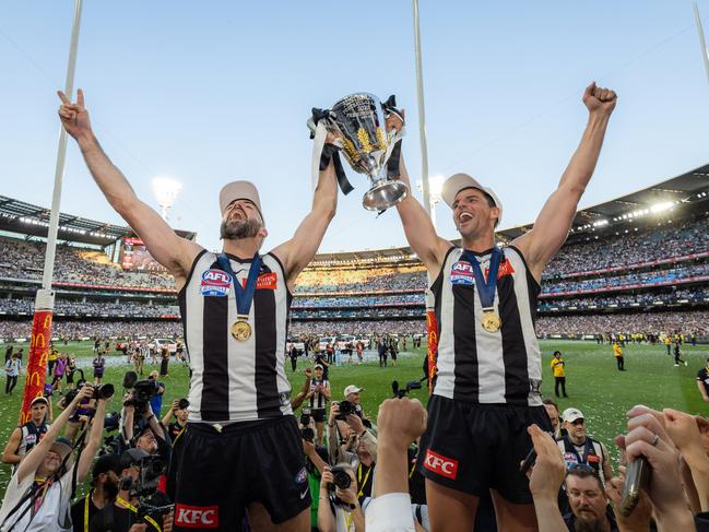 MELBOURNE , AUSTRALIA. September 30, 2023. AFL Grand Final between Collingwood and the Brisbane Lions at the MCG. After the siren, Collingwood wins. Steele Sidebottom and Scott Pendlebury. Picture by Jason Edwards