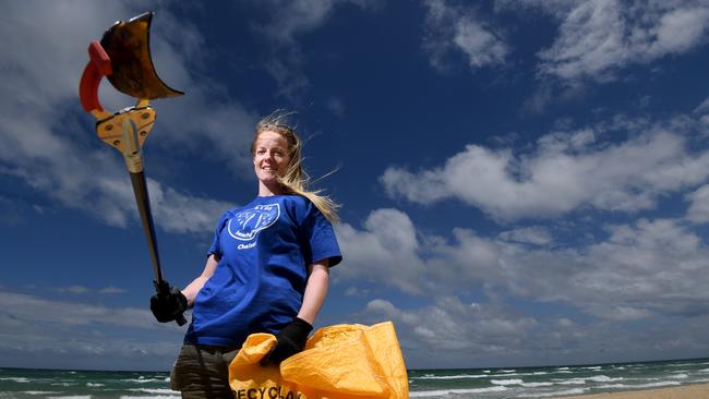 3196 beach patrol zone manager Lucy Bonham collects rubbish at Bonbeach. Picture: Penny Stephens