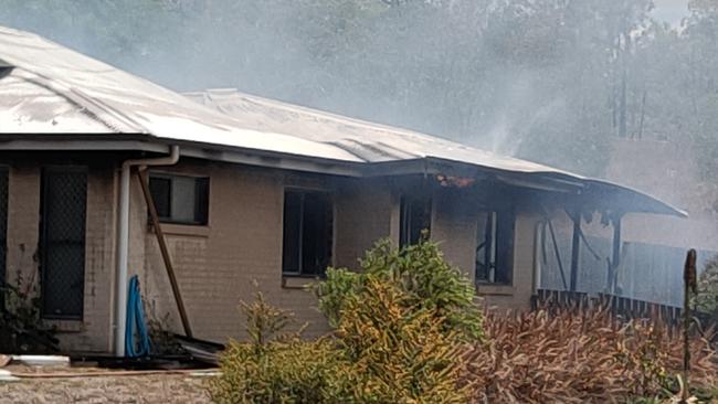 Flames could be seen licking at the eaves of a Calliope home on Sybil Court that was destroyed by fire on Boxing Day. Picture: Rodney Stevens