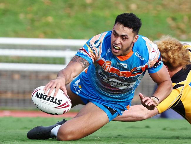 Pride's Jensen Taumoepeau gets past Caius Faatili to score a try in the Hostplus Cup Queensland Rugby League (QRL) match between the Northern Pride and the Sunshine Coast Falcons, held at Barlow Park, Cairns Picture: Brendan Radke