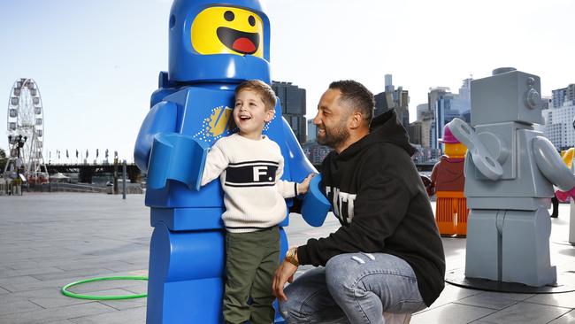 Darling Harbour in Sydney: Former NRL star Benji Marshall and his son Fox at the Lego 90 year celebration installation. Picture: Richard Dobson