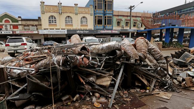 Damaged furniture and store goods from businesses along Woodlark St, Lismore laid strewn along the footpath and street ready for collection in the aftermath of the 2022 floods. Picture: Toby Zerna