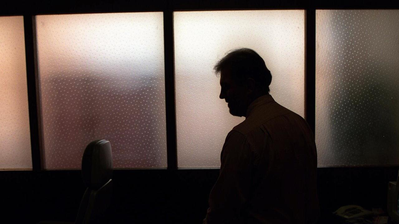 Generic image. Silhouette of a man (parent of) a sex abuse victim in an office. wrongly accused of touching young girl. Child sexual abuse. sex crime incest paedophilia.