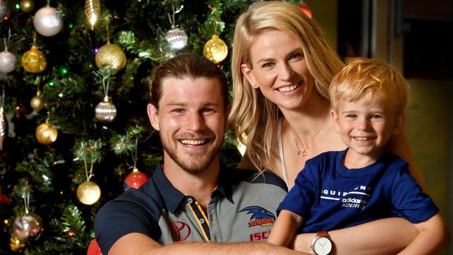 HAPPY TO BE HOME: Star Adelaide Crows recruit Bryce Gibbs with fiancee Lauren  and son Charlie, 2, get into the Christmas spirt at the club’s West Lakes headquarters. Picture: Tricia Watkinson.