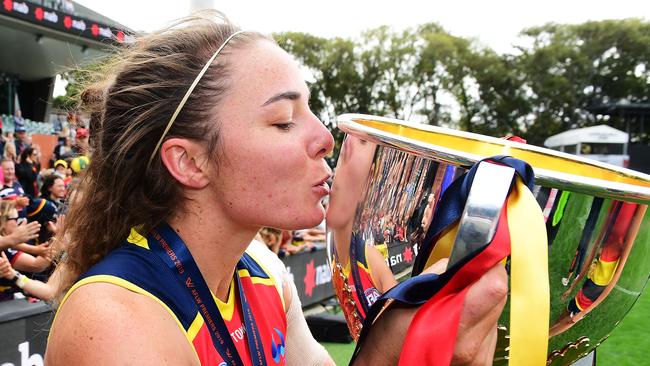 Jenna McCormick kisses the AFLW premiership cup, which she won with the Adelaide Crows this year. Picture: Mark Brake/Getty Images