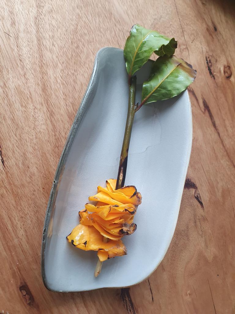 Pumpkin brushed with fermented black bean, served with a bay leaf. Picture: Charis Chang