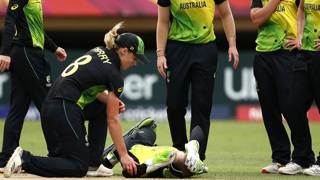 PROVIDENCE, GUYANA - NOVEMBER 17: Alyssa Healy of Australia lies on the wicket injured after crashing into team mate Megan Schutt going for a catch during the ICC Women's World T20 2018 match between India and Australia at Guyana National Stadium on November 17, 2018 in Providence, Guyana. (Photo by Jan Kruger-IDI/IDI via Getty Images)