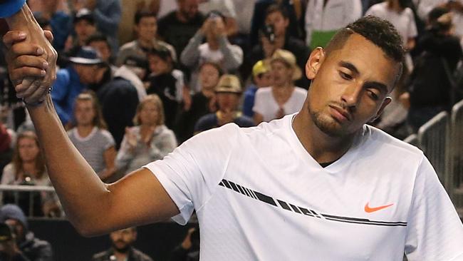 Nick Kyrgios shakes hands with the umpire after losing his second round match against Andreas Seppi. Picture: Wayne Ludbey