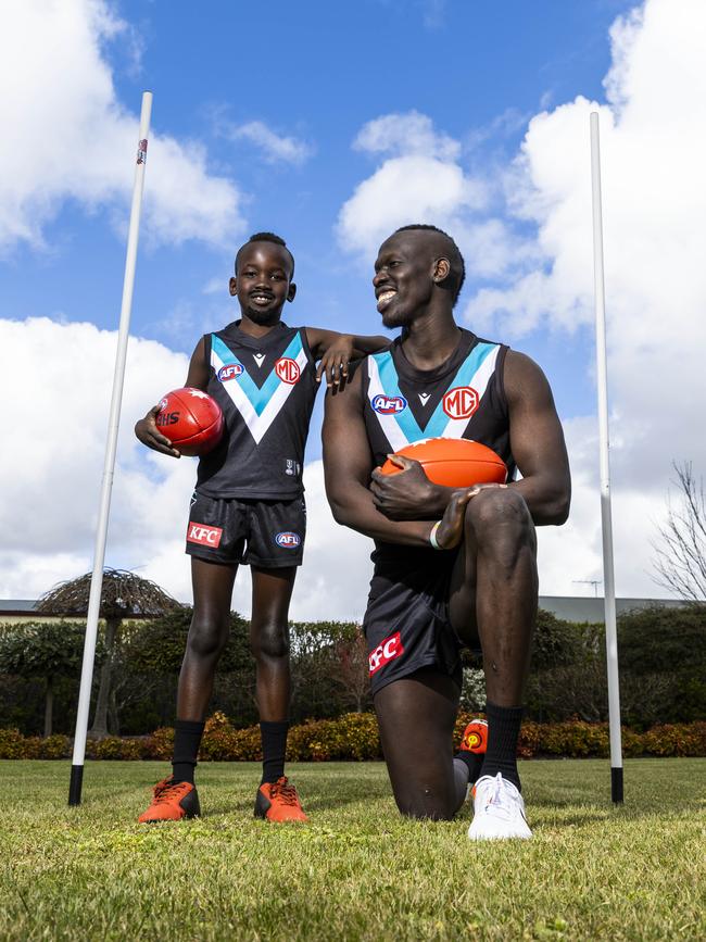 12/09/22 - Port Adelaide footballer Aliir Aliir with his NAB Mini Legend child Timothy Kuol (8). Aaron Francis / Herald Sun