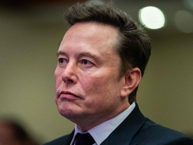 Elon Musk listens as US President-elect Donald Trump speaks during a meeting with House Republicans at the Hyatt Regency hotel in Washington, DC on November 13, 2024. (Photo by Allison ROBBERT / POOL / AFP)