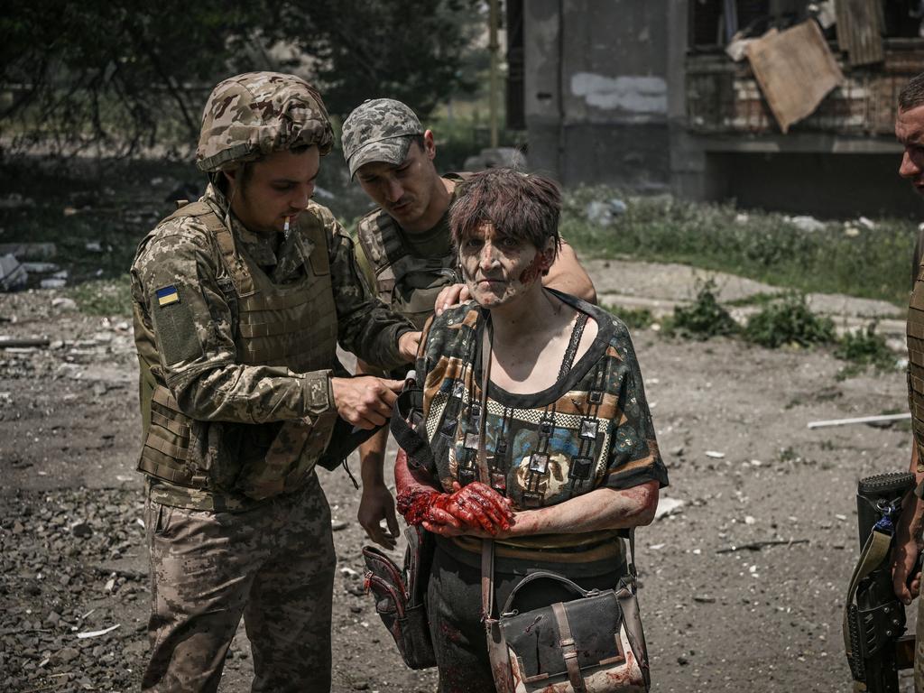 A wounded woman is treated by Ukrainian servicemen during an artillery duel between Ukrainian and Russian troops in the city of Lysychansk, eastern Ukrainian region of Donbas. Picture: AFP