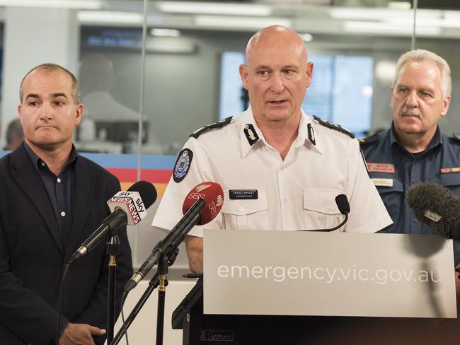 Acting Premier and Minister for Emergency Services James Merlino, Emergency Management Commissioner Craig Lapsley, and Ambulance Victoria State Health Commander Paul Holman at the State Control Centre in Melbourne. Picture: AAP Image/Ellen Smith