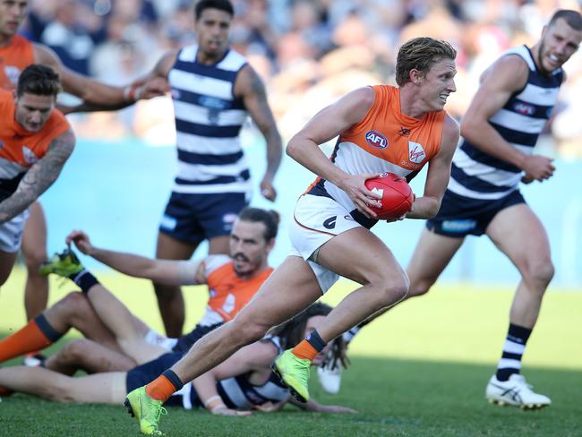 Lachie Whitfield of the Giants AFL Round 4. 13/04/2019. Geelong v GWS Giants at GMHBA Stadium .   Lachie Whitfield of the Giants charges through half back   . Pic: Michael Klein.