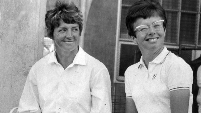 Margaret Court, wearing her husband's long-sleeve shirt and long socks as protection against sunburn, with her old rival Billie-Jean King at Kooyong. Tennis. Melbourne.