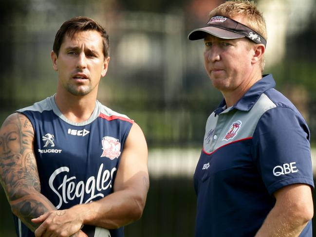 Mitchell Pearce  talks to coach Trent Robinson at training with the Sydney Roosters ahead of his return in the game against the Newcastle Knights at Allianz Stadium . Picture : Gregg Porteous