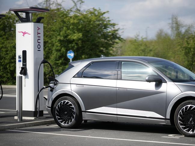 LEEDS, ENGLAND - APRIL 26: A Hyundai Ioniq battery electric vehicle (BEV) charges at an Ionity GmbH electric car charging station at Skelton Lake motorway service area on April 26, 2022 in Leeds, England. According to a report from the Society of Motor Manufacturers And Traders, there were more new electric vehicle registrations in the UK in March 2022 than all of 2019. However, overall car sales slumped amid rising fuel prices and the car industry's supply chain problems. (Photo by Christopher Furlong/Getty Images)