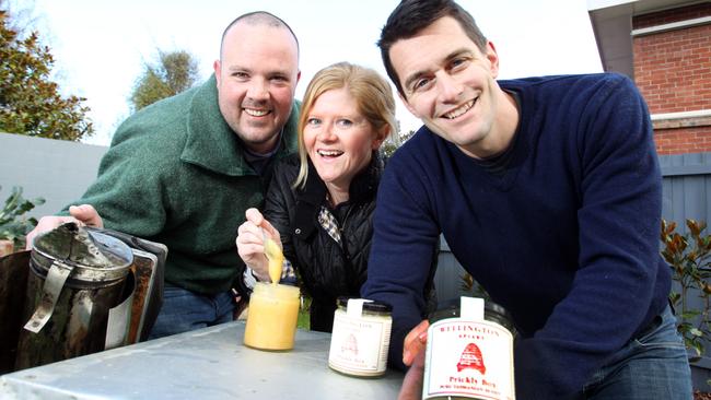 Wellington Apiary owners, Robin O'Brien (right) and his wife, Antonia O'Brien with Apiculture apprentice, Nick Graham of Kingston(left) and some of their now famous honey.