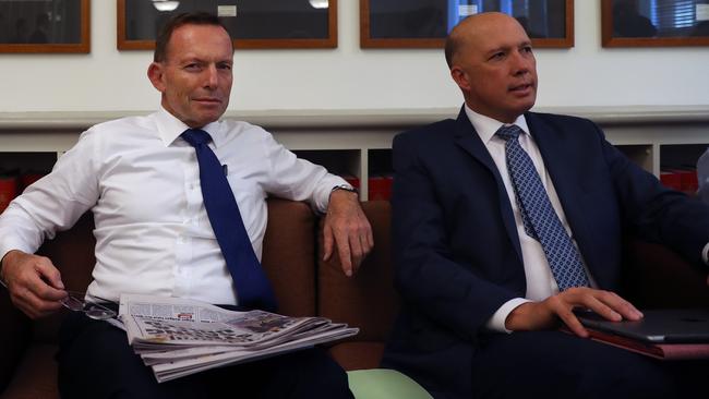 Tony Abbott and Peter Dutton sat beside each other during the government’s joint party room meeting. Picture: Gary Ramage