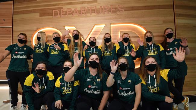 Australian softball players wave as they pose for a group picture prior to their departure for the Tokyo Olympics, at Sydney International Airport. Picture: SAEED KHAN / AFP.