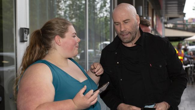 Actor John Travolta poses for photos with a fan in Adelaide’s CBD. Picture: AAP/Emma Brasier