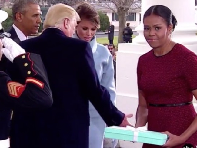 Michelle Obama’s expression says it all. It almost looks as if she’s already trying to work out who to re-gift it to.