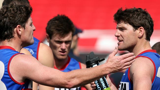 James (left) and Chris Gowans have a heated discussion at three-quarter time of the first semi-final against North Adelaide in 2012.