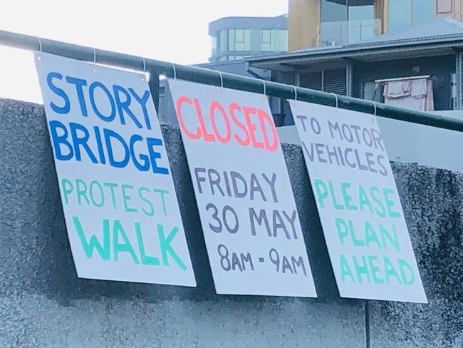 Protest signs near the Story Bridge warning drivers of a pending protest which the courts have blocked
