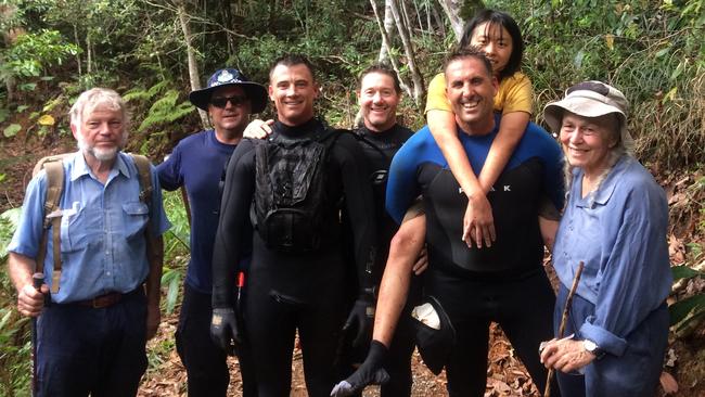 Members of the Gold Coast search and rescue team with missing Chinese woman Yang Chen who had been missing for five days near Gorge Falls at Tallebudgera. Picture: QPS