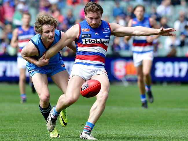 Central's Jarrod Schiller tries to get away from Sturt's Benjamin Hansen.