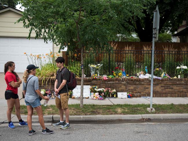 People gather next to a memorial for Justine Damond near where she was shot and killed by police. Picture: AFP