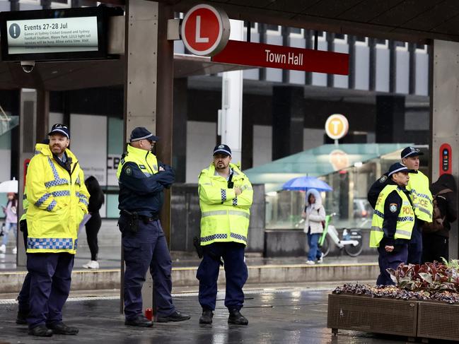 Police weathering early morning rain. Picture: Tim Hunter.