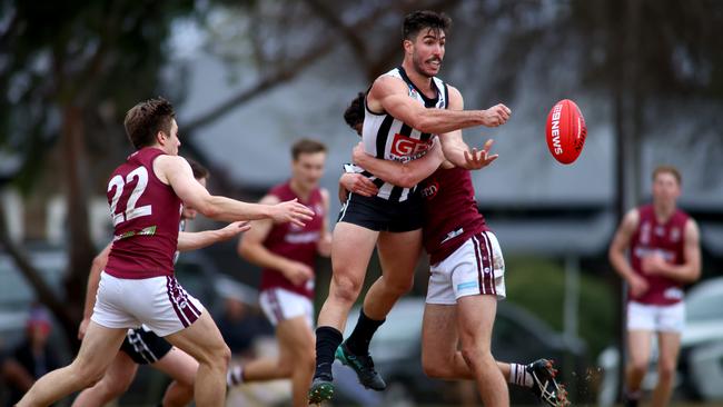 Falcons captain Jonathan Giannini fires out a handball. Picture: Kelly Barnes