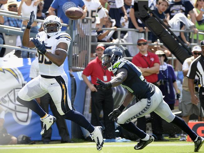 Tight end Antonio Gates #85 of the San Diego Chargers catches a pass for a touchdown while defended by strong safety Kam Chancellor #31.