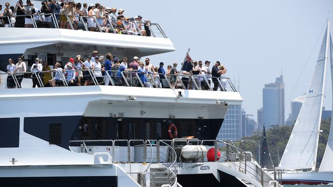 Thousands watch the start from boats and other craft.