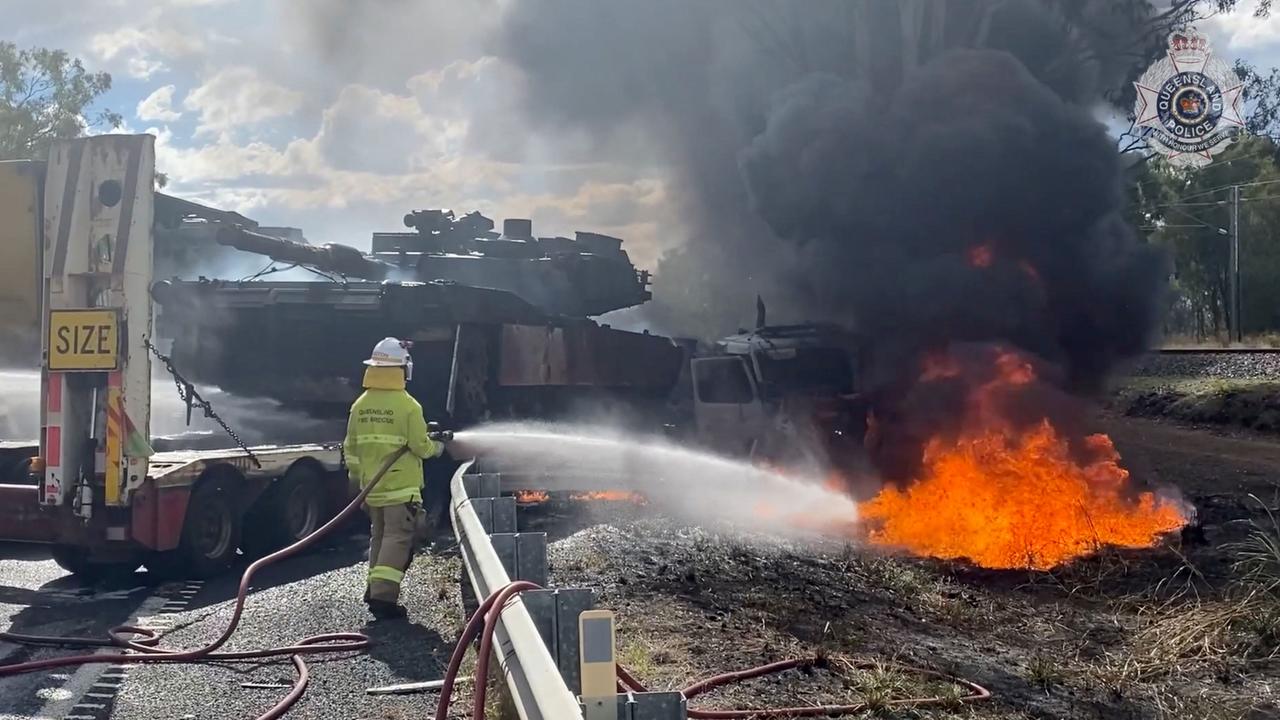 A firefighter at near Bajool, after a collision between seven vehicles, including a semi-trailer carrying a US military tank that was to be used in war games. Photo: Queensland Police Service via AFP