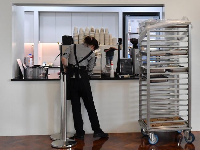 A worker cleans the coffee machine at the Coffee Hub in the Press Gallery at Parliament House in Canberra. Picture: AAP