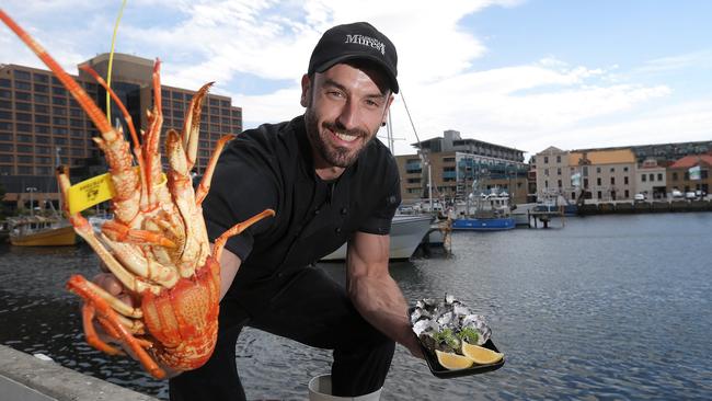 Jono Douglas from Mures with a Southern Rock Lobster and oysters for sale for Christmas day PICTURE: Luke Bowden