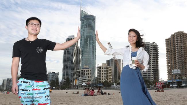 Chinese tourists are flocking to the Gold Coast in large numbers. Weihua Chen (23) and Dongwan Wang (22) having fun on Surfers Paradise beach. Picture: Scott Fletcher