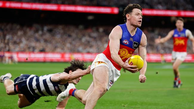 Lachie Neale of the Lions evades Gryan Miers of the Cats during the 2024 AFL second preliminary final match at The Melbourne Cricket Ground on September 21. Picture: Dylan Burns/AFL Photos via Getty Images.