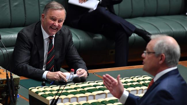 Anthony Albanese bursts into laughter as Scott Morrison addresses MPs during question time on Thursday. Picture: Getty Images