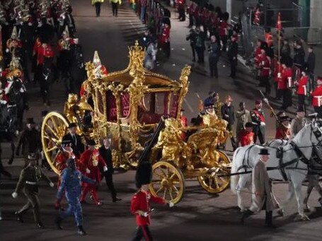 The gold state coach during rehearsals in London, late Tuesday night. Picture: PA