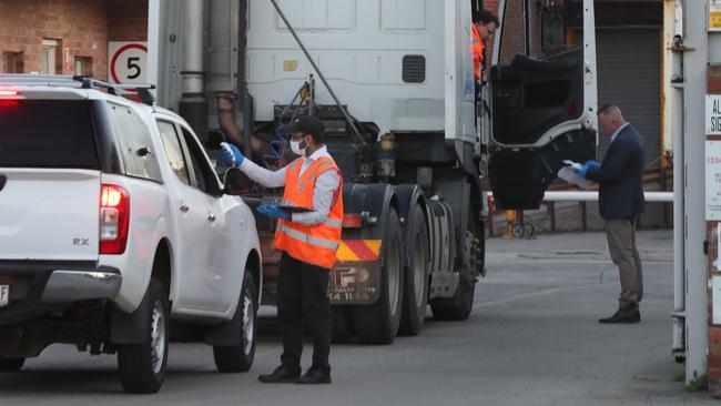 Gates reopen: Workers arrive at Cedar Meats this morning after a coronavirus outbreak forced it to close more than two weeks ago. Picture: David Crosling