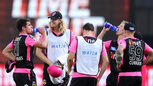 PERTH, AUSTRALIA - DECEMBER 26: Moises Henriques and Jordan Silk of the Sixers take a drink at time-out during the Big Bash League match between the Perth Scorchers and the Sydney Sixers at Optus Stadium on December 26, 2019 in Perth, Australia. (Photo by Paul Kane/Getty Images)