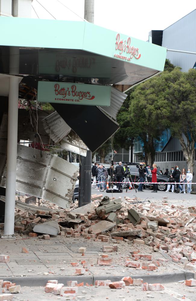 Melburnians survey the damage at a building in Chapel St in Prahran. Picture: Andrew Henshaw