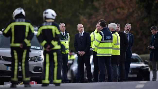Ireland’s premier Micheal Martin talks to emergency workers at the scene of the Applegreen service station explosion, where 10 people died. Picture: Getty Images
