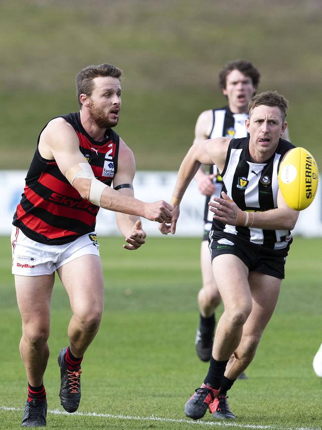 Nat Franklin (left) fires off a handball during a TSL game against Glenorchy at KGV earlier in the year. Picture: Chris Kidd