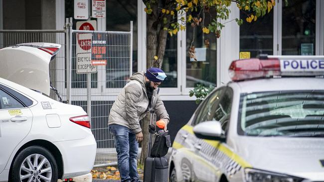 A guest leaves the Pullman Hotel, Adelaide after spending 14 days in isolation after arriving from overseas two weeks ago. Photo: MIKE BURTON