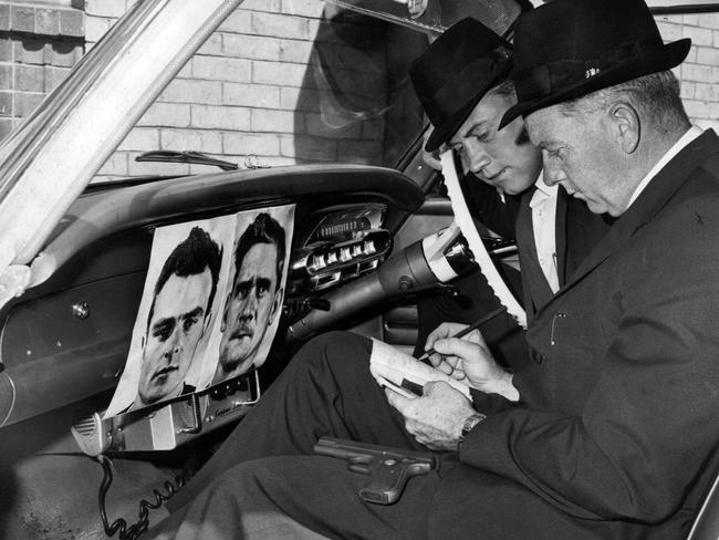 Police with pictures of Pentridge escapees Peter Walker and Ronald Ryan in 1965.