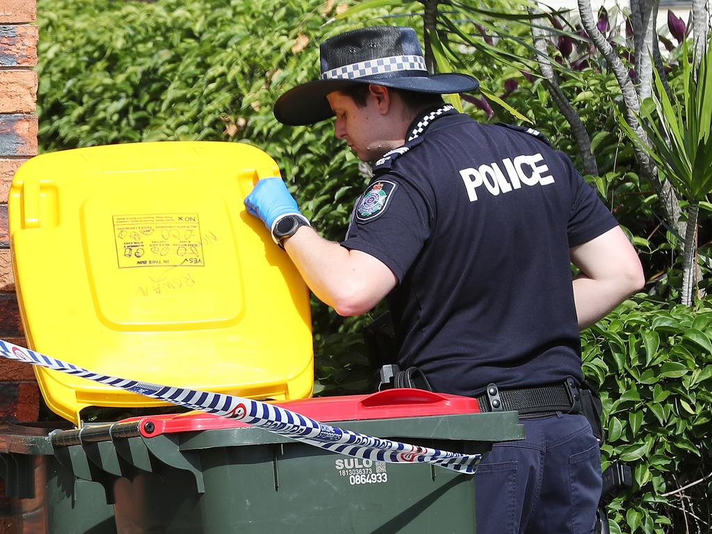 A police photographer searchers the home of Rowan Baxter. Picture: Liam Kidston