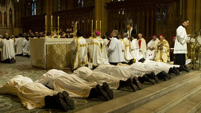 The seven new priests lay face down at the altar in a show of complete submission to God. Picture: Brendan Read